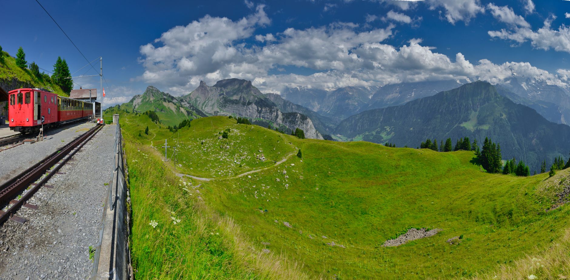 Scenic train winding through alpine mountain ridges